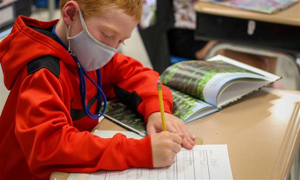 student works at desk